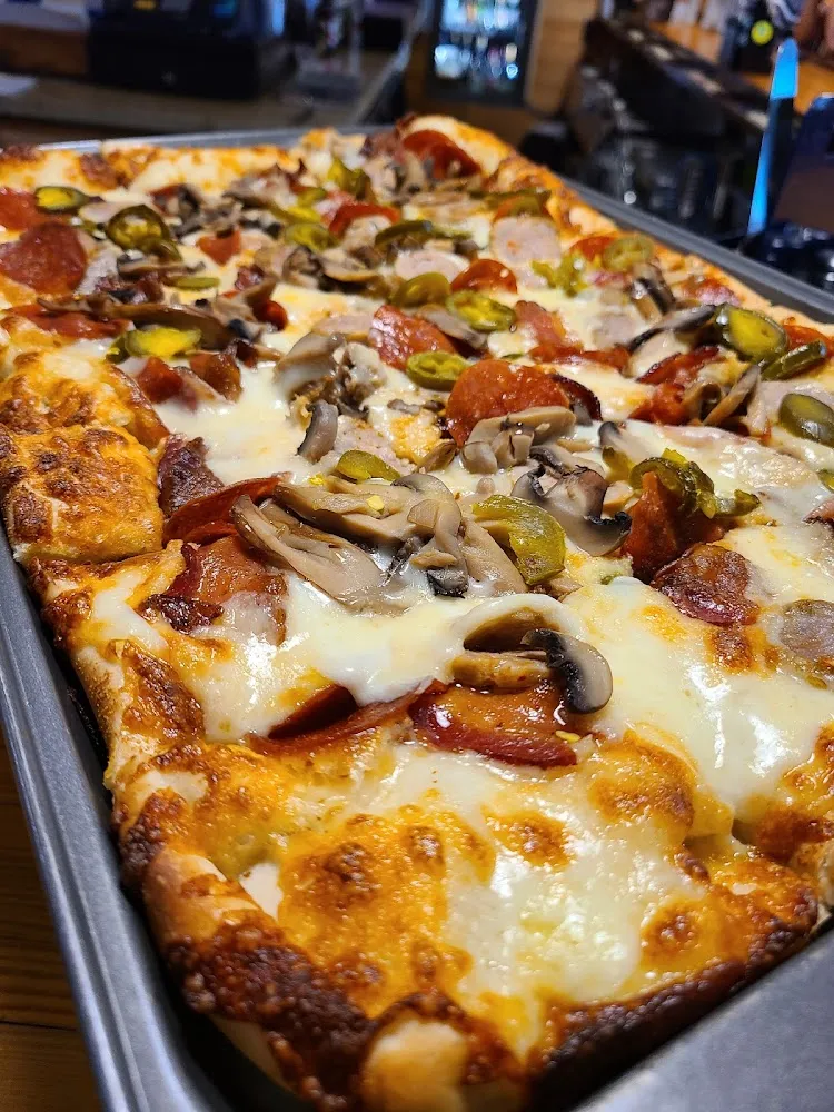 Garlic Mushroom Pepperoni Sausage Bacon and Jalapeño Pizza